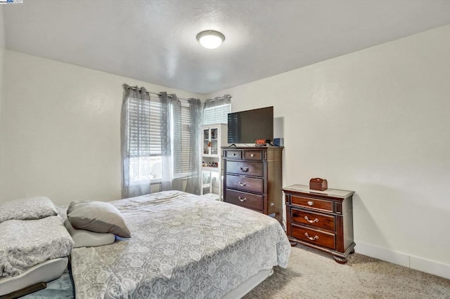 bedroom featuring light colored carpet