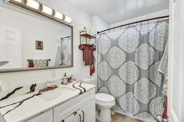 bathroom featuring tile patterned flooring, vanity, walk in shower, and toilet