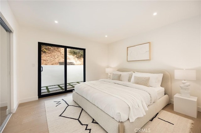 bedroom with light hardwood / wood-style flooring and access to outside