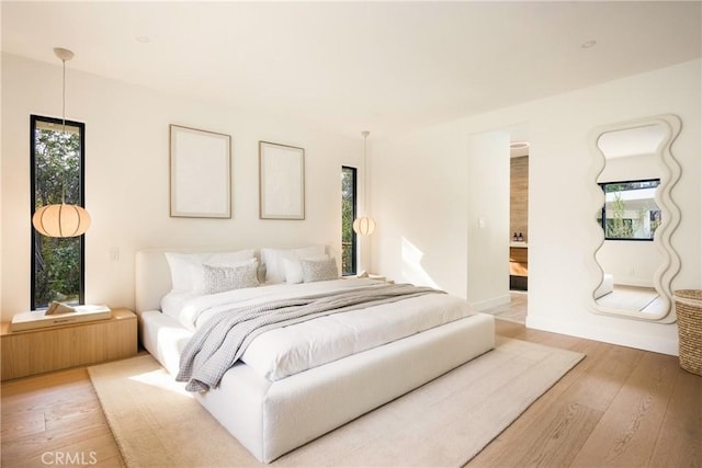 bedroom featuring light wood-type flooring and multiple windows