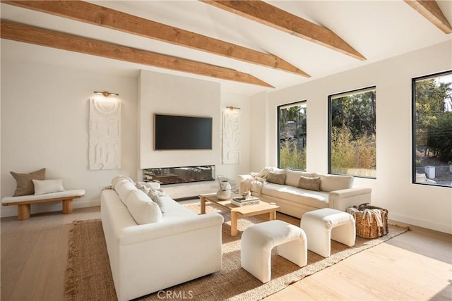 living room with hardwood / wood-style floors and vaulted ceiling with beams