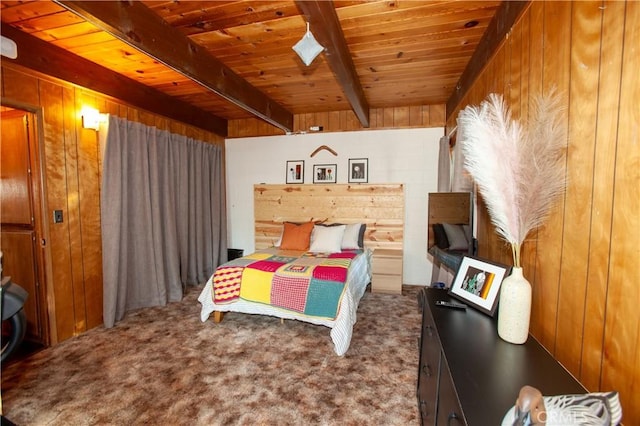 carpeted bedroom with beam ceiling, wooden walls, and wooden ceiling