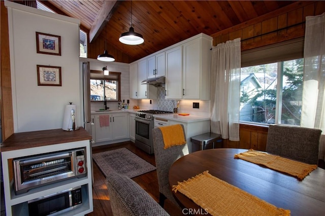 kitchen featuring pendant lighting, sink, white cabinets, high end stainless steel range, and wood ceiling