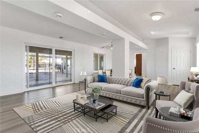 living area with wood finished floors and visible vents