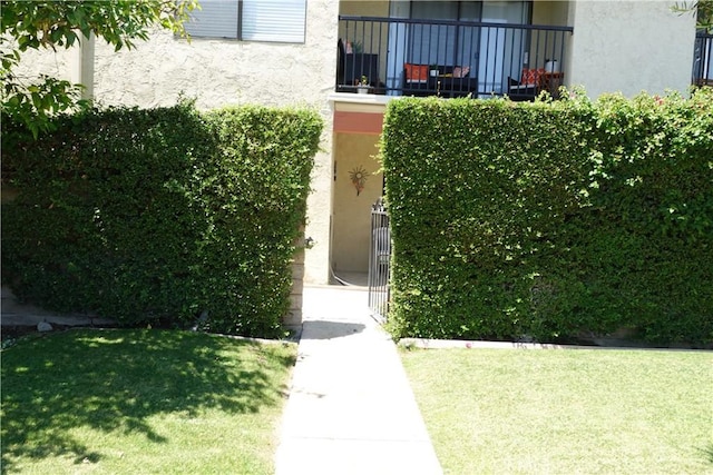 view of exterior entry featuring a yard