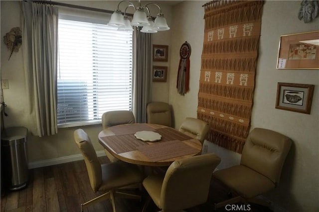 dining space featuring a notable chandelier and dark wood-type flooring