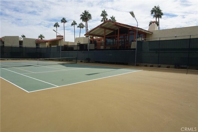 view of tennis court featuring basketball court