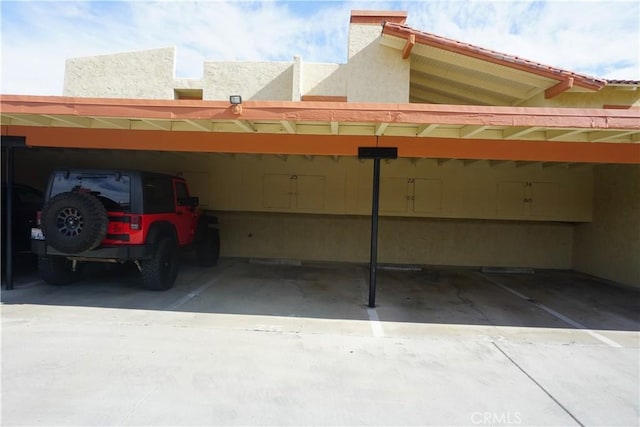 view of vehicle parking with a carport