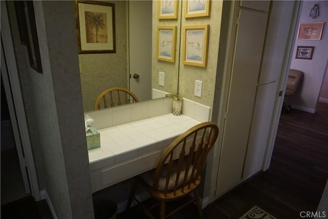 interior space featuring dark hardwood / wood-style flooring and built in desk