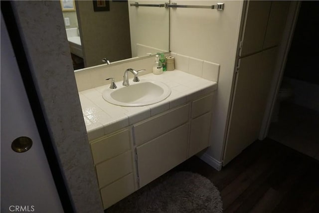 bathroom with vanity and hardwood / wood-style flooring