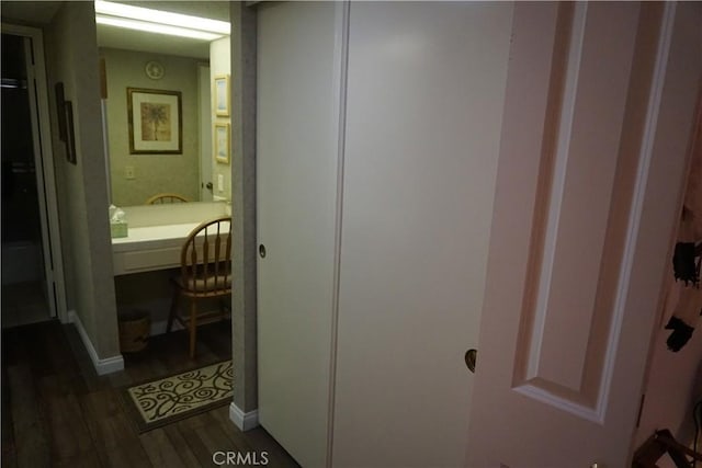 corridor with dark wood-type flooring