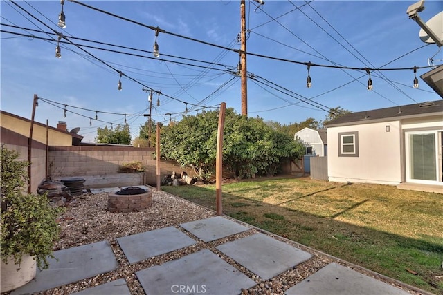 view of yard with a patio area and an outdoor fire pit