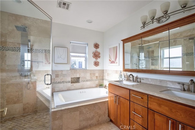 bathroom featuring vanity, tile patterned flooring, and shower with separate bathtub