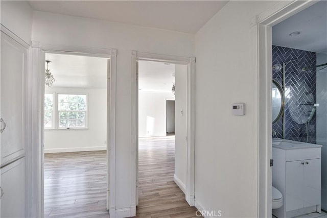 corridor with light wood-type flooring