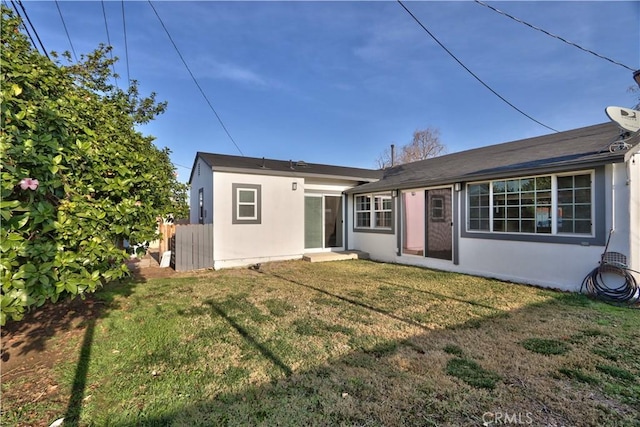 rear view of house with a yard