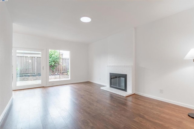 unfurnished living room featuring hardwood / wood-style floors and a fireplace