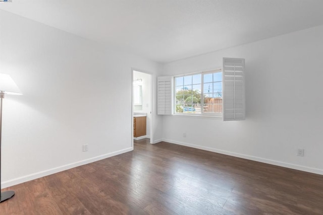 spare room featuring dark hardwood / wood-style flooring