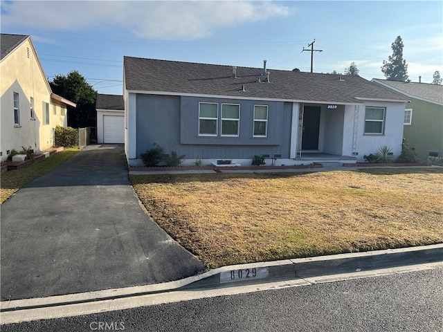 ranch-style house with roof with shingles, crawl space, a garage, an outdoor structure, and a front lawn