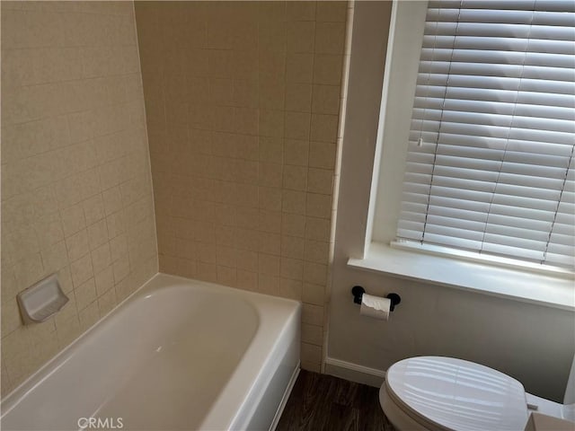 full bathroom with toilet and baseboards