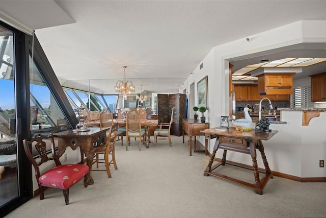 carpeted dining area featuring sink and a notable chandelier