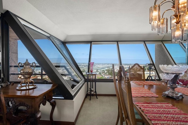 sunroom featuring a notable chandelier