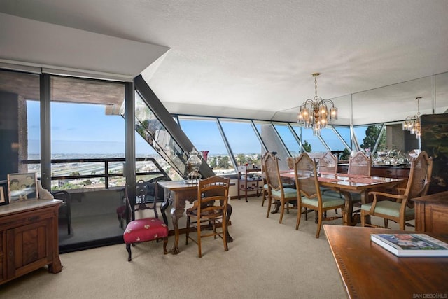 dining space featuring a notable chandelier, light colored carpet, and a water view