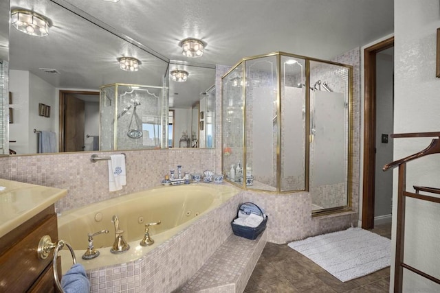 bathroom with tile patterned floors, vanity, and separate shower and tub