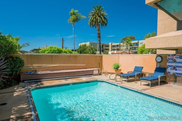 view of pool with a hot tub and a patio