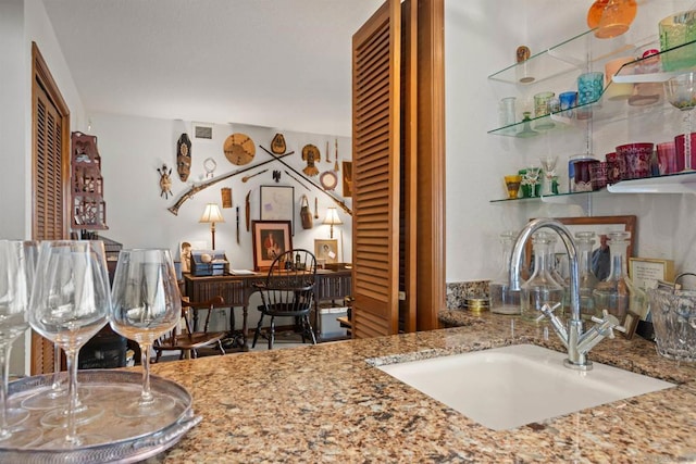 interior space with sink and stone counters