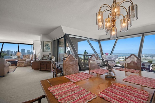 dining space featuring a notable chandelier and a textured ceiling