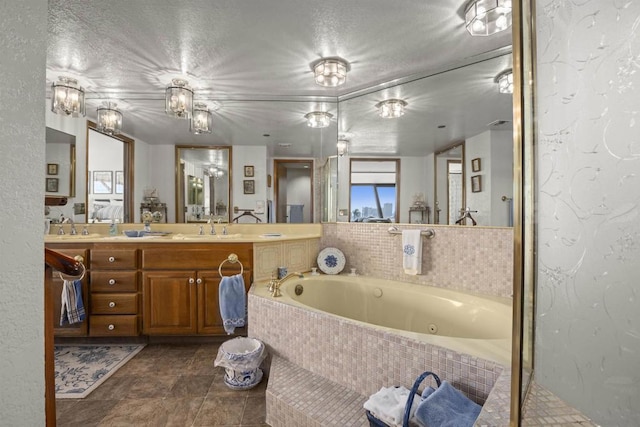 bathroom with vanity, independent shower and bath, and a textured ceiling