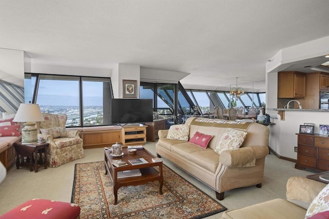 carpeted living room featuring an inviting chandelier and a wealth of natural light