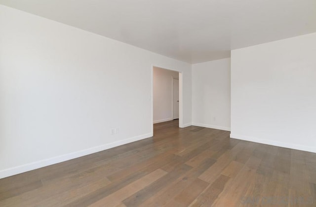 spare room with dark wood-type flooring