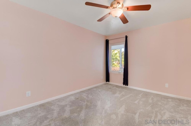 spare room featuring light colored carpet