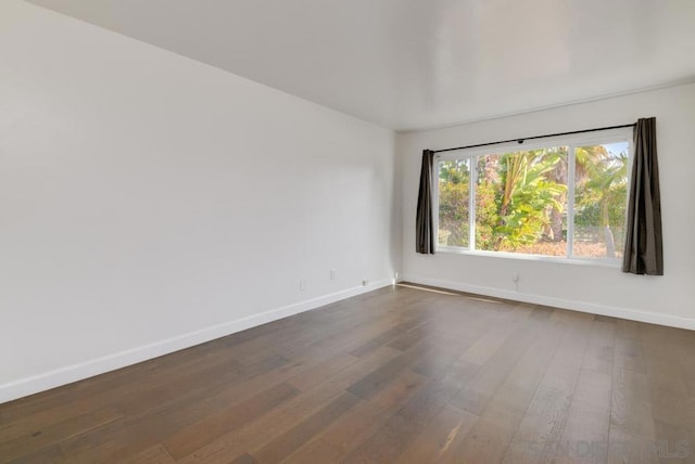 spare room featuring dark hardwood / wood-style floors