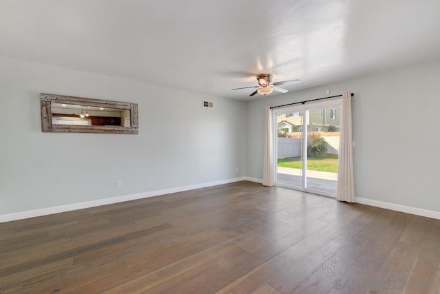 empty room with dark hardwood / wood-style flooring and ceiling fan