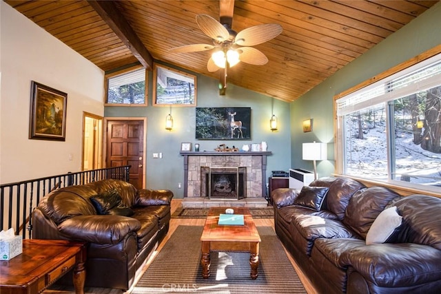 living room with a tiled fireplace, vaulted ceiling with beams, wooden ceiling, and ceiling fan