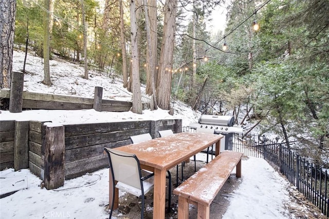 snow covered deck featuring grilling area