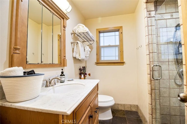 bathroom featuring vanity, an enclosed shower, and toilet