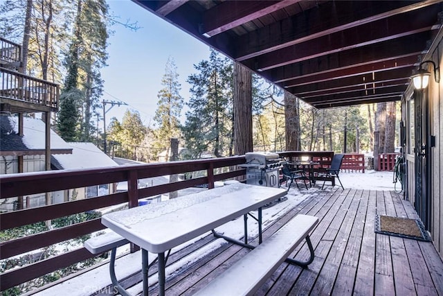 wooden terrace featuring a grill