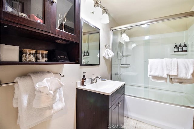 bathroom featuring vanity, combined bath / shower with glass door, and tile patterned floors