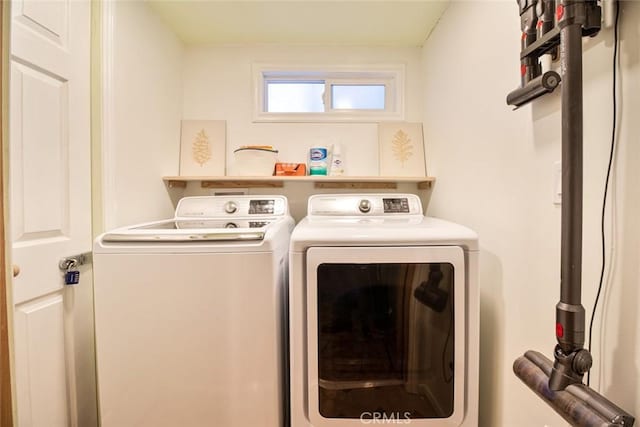 clothes washing area featuring independent washer and dryer