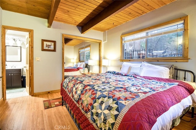 bedroom with connected bathroom, beamed ceiling, sink, light hardwood / wood-style floors, and wooden ceiling