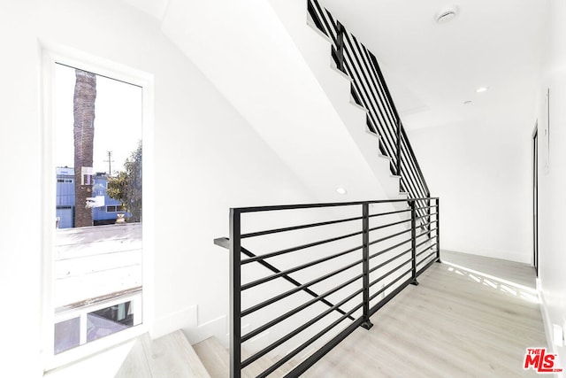 stairs with hardwood / wood-style flooring