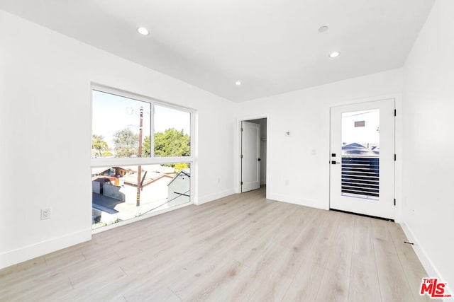 spare room featuring light wood-type flooring