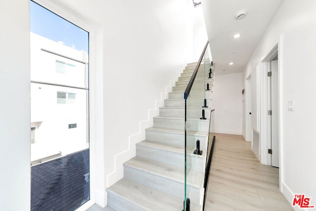 stairs with hardwood / wood-style floors