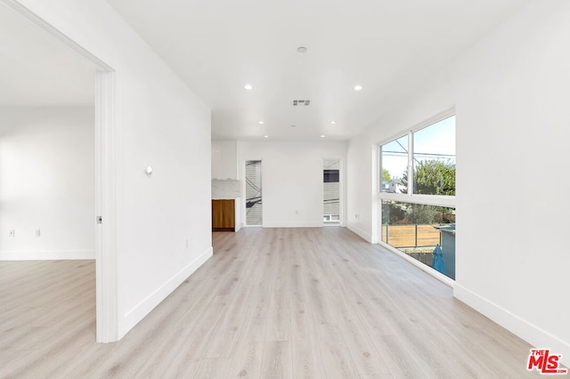 unfurnished living room with light hardwood / wood-style flooring