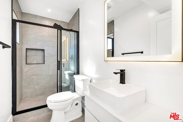 bathroom with vanity, walk in shower, and toilet