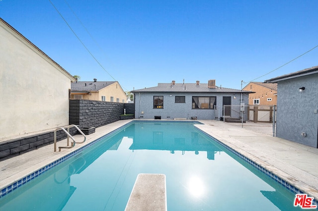 view of pool featuring a diving board