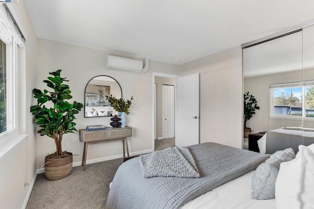 bedroom with carpet floors, a closet, and an AC wall unit